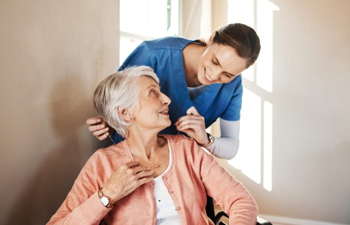 Shot of a senior woman in a wheelchair being cared for a nurse