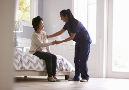Nurse Making Home Visit To Senior Woman